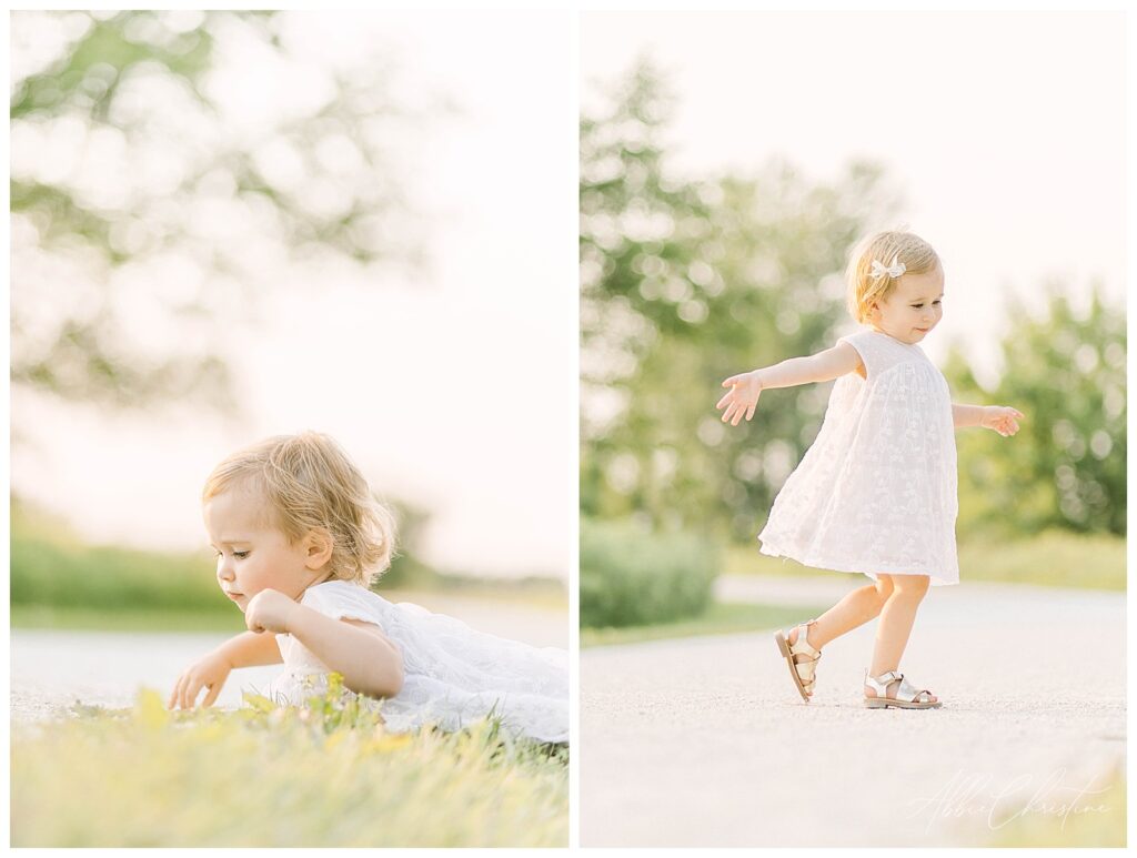 Two year old girl in white dress dances dances on gravel path near a tree in Chicago, Il. 